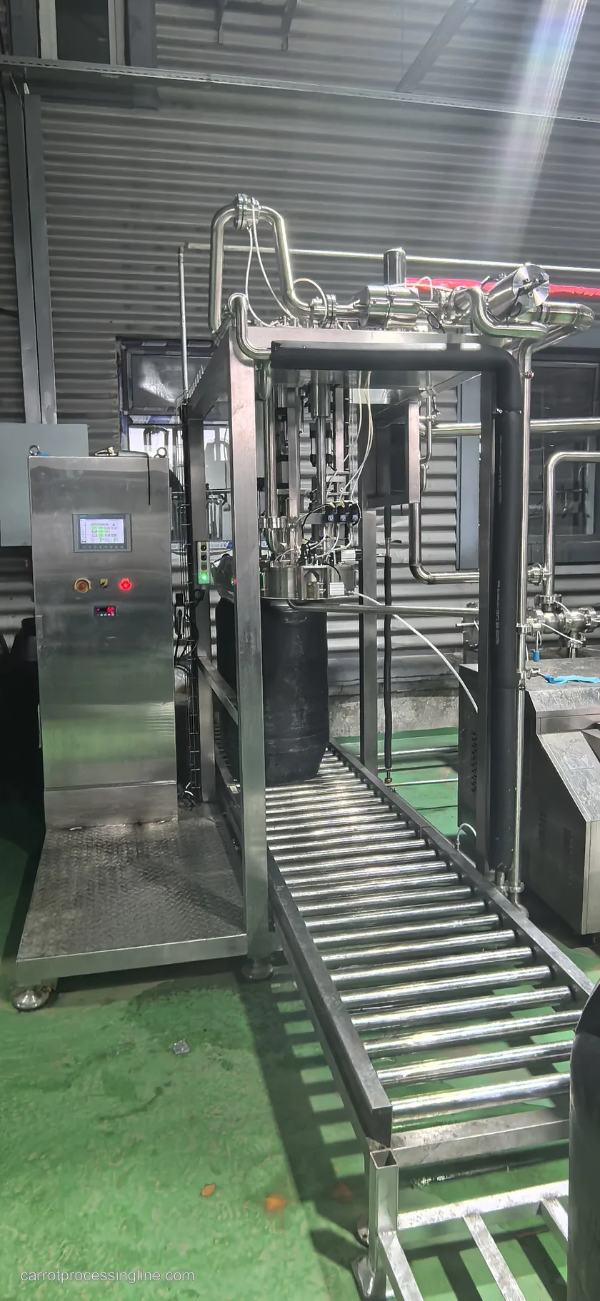 Vertical view of an industrial aseptic filler and roller conveyor